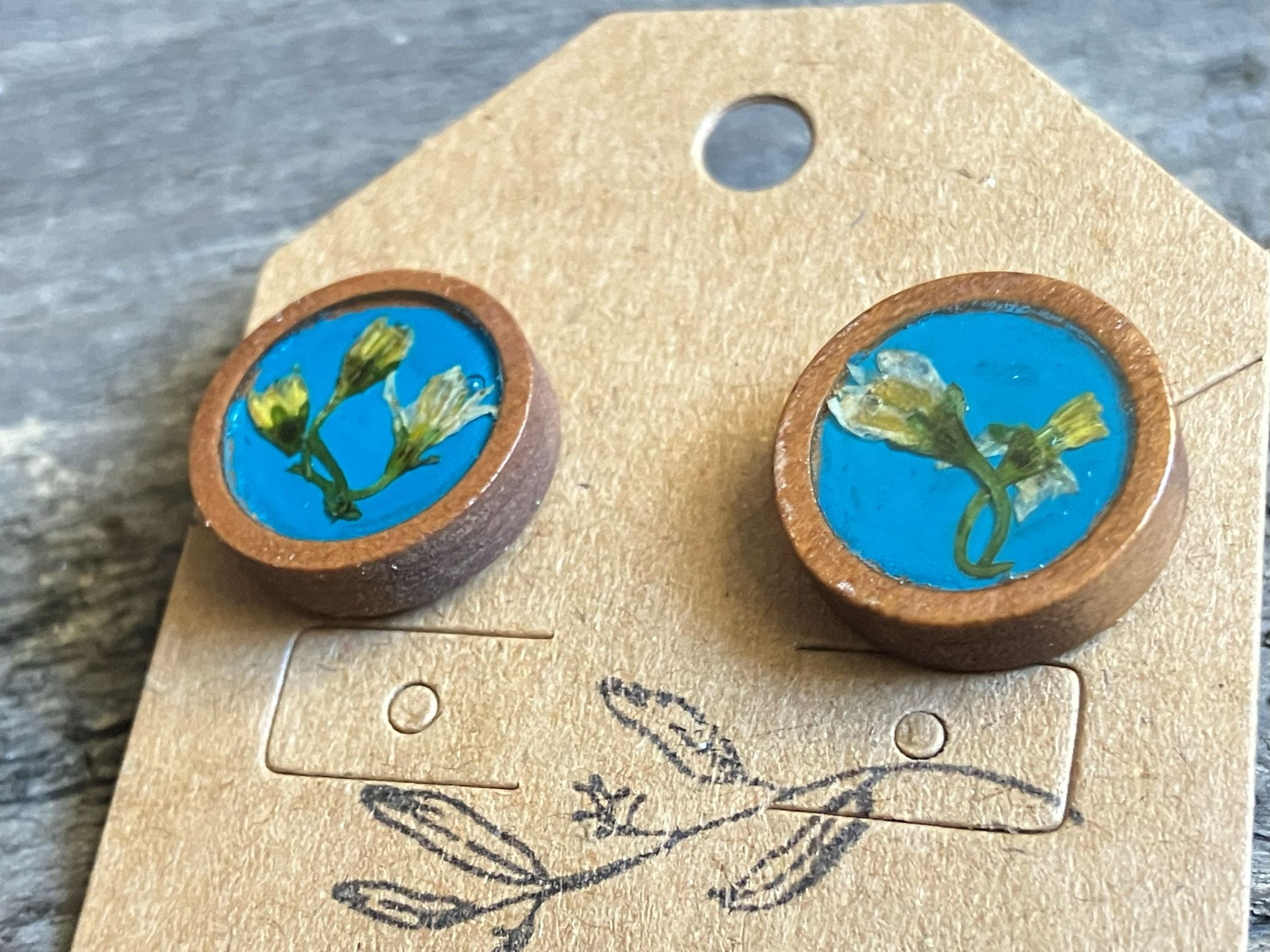 Hand-painted blue wooden stud earrings with real Jerusalem weed preserved in resin by R & D Floral.